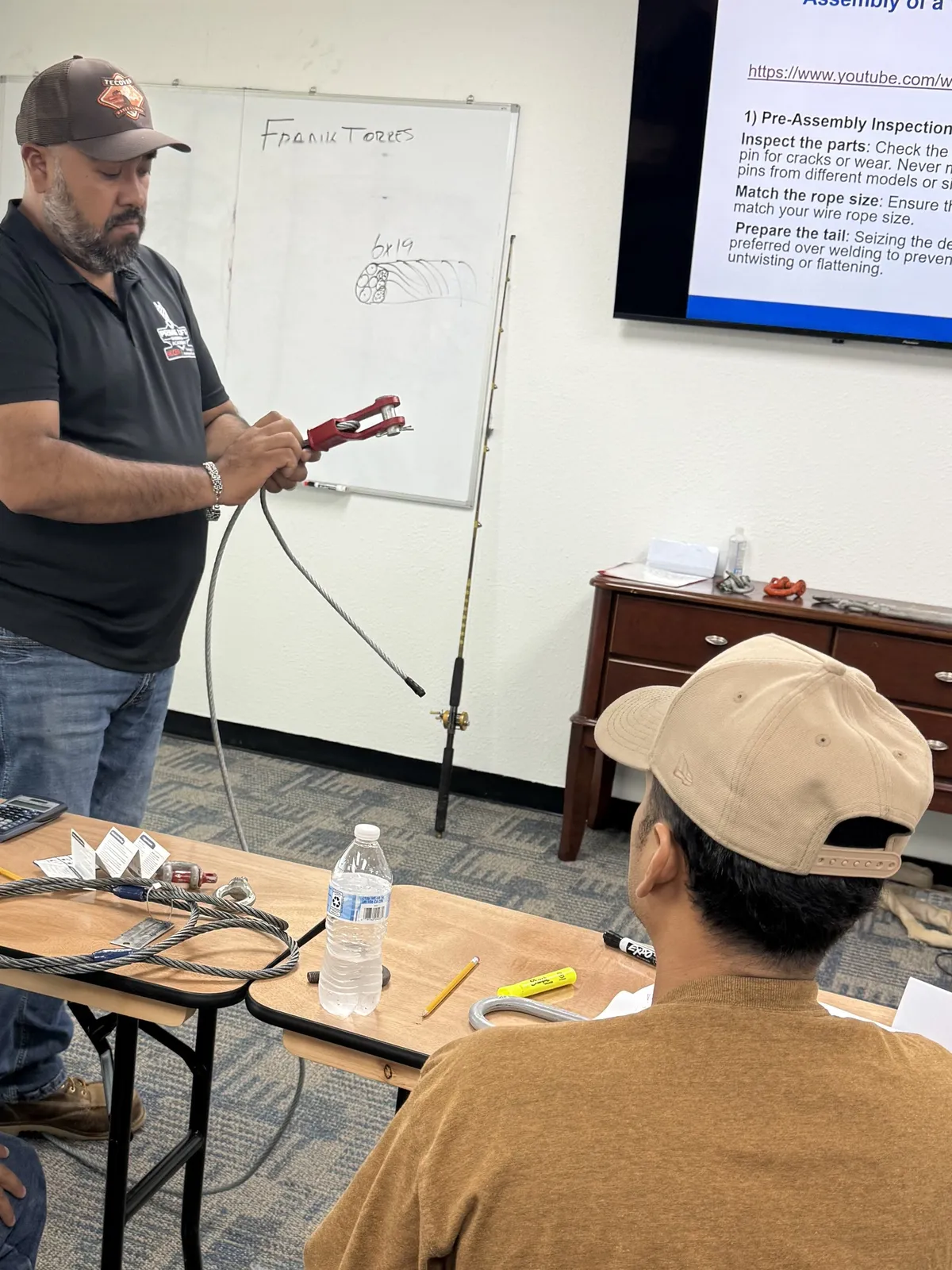 Instructor Frank Torres showing a class how to assemble a terminator wedge socket on wire rope