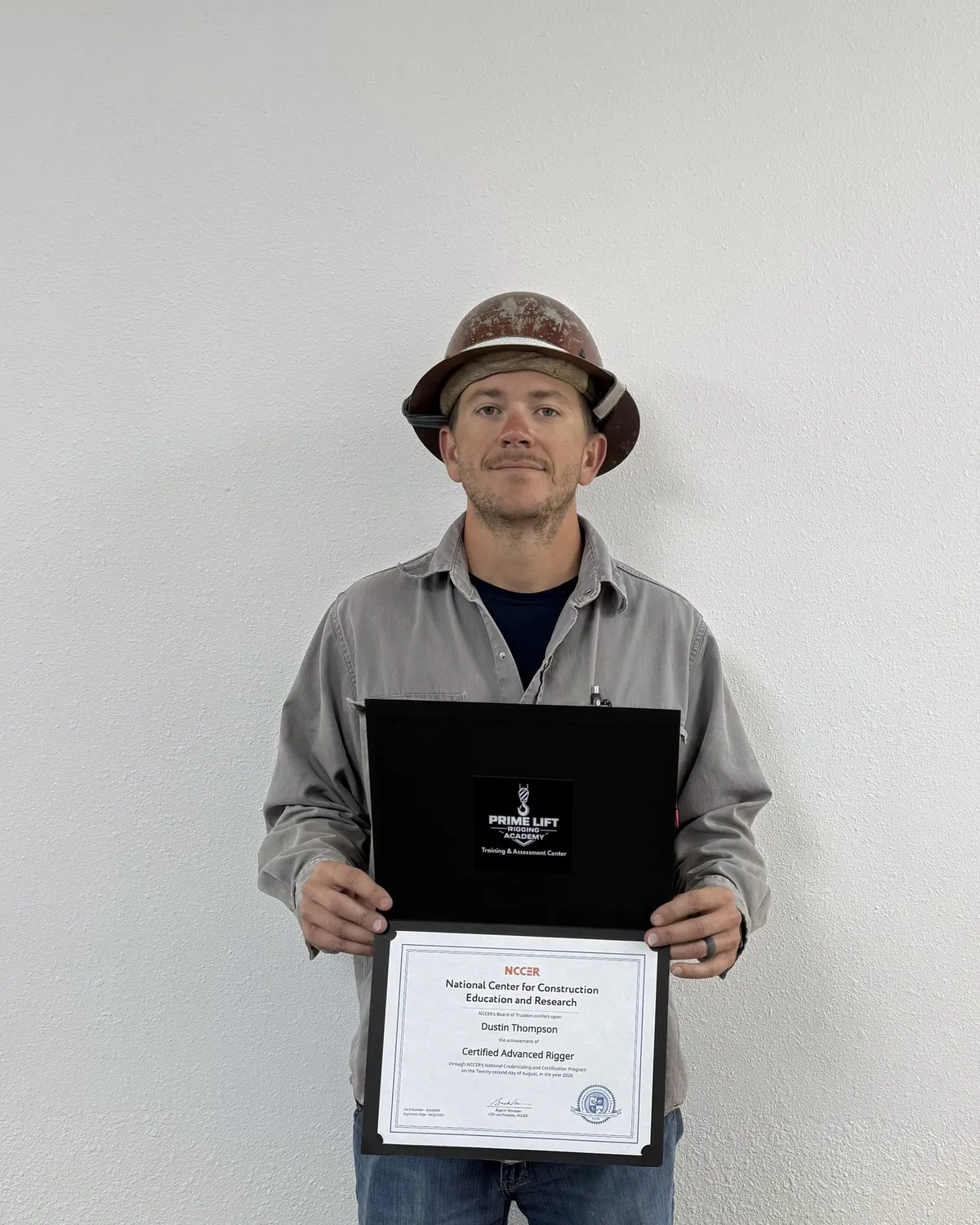 Dustin T., a Prime Lift graduate, holding his NCCER Certified Advanced Rigger certificate