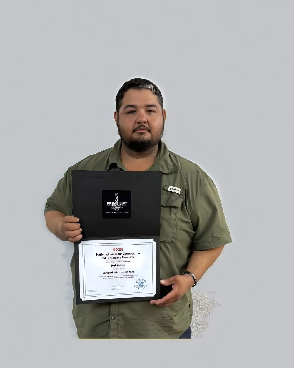 Joel A., a Prime Lift graduate, holding his NCCER Certified Advanced Rigger certificate