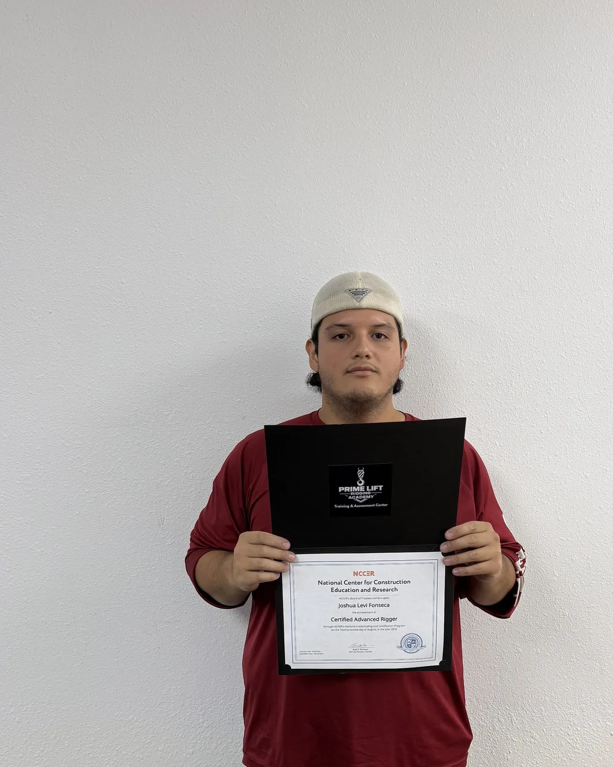 Joshua F., a Prime Lift graduate, holding his NCCER Certified Advanced Rigger certificate