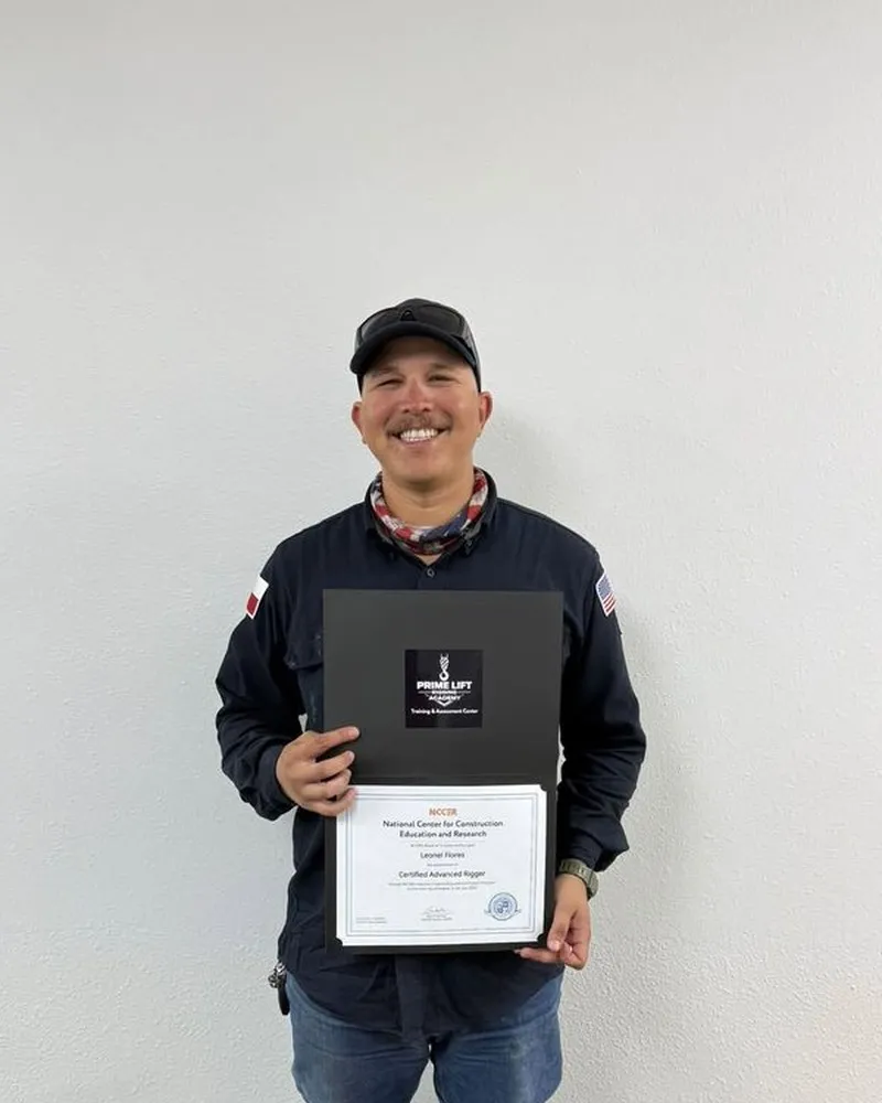 Leonel F., a Prime Lift graduate, holding his NCCER Certified Advanced Rigger certificate