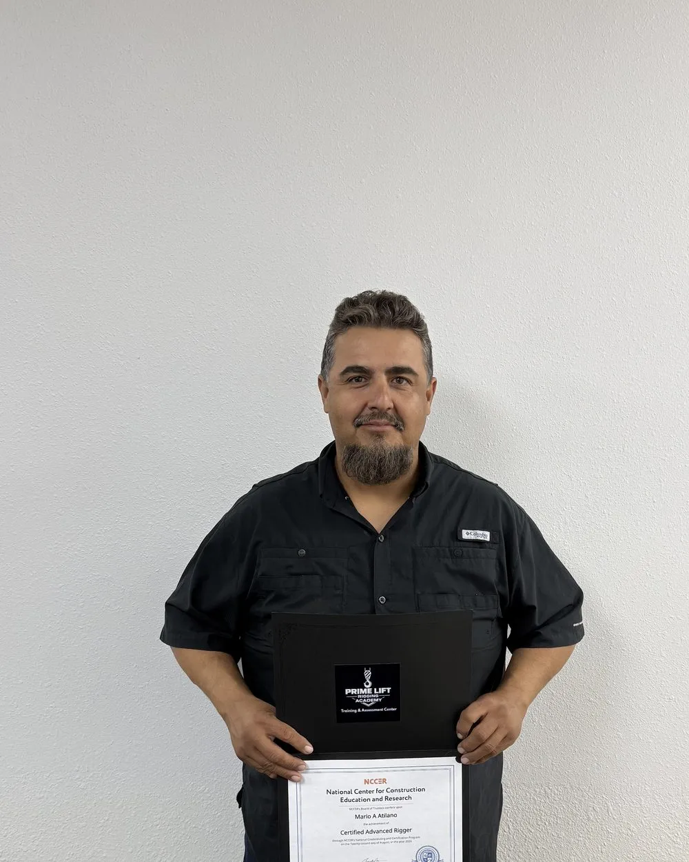 Mario A., a Prime Lift graduate, holding his NCCER Certified Advanced Rigger certificate