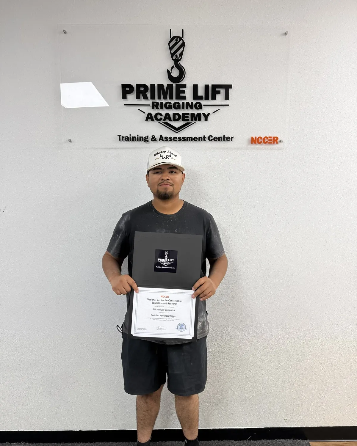 Michael C., a Prime Lift graduate, holding his NCCER Certified Advanced Rigger certificate