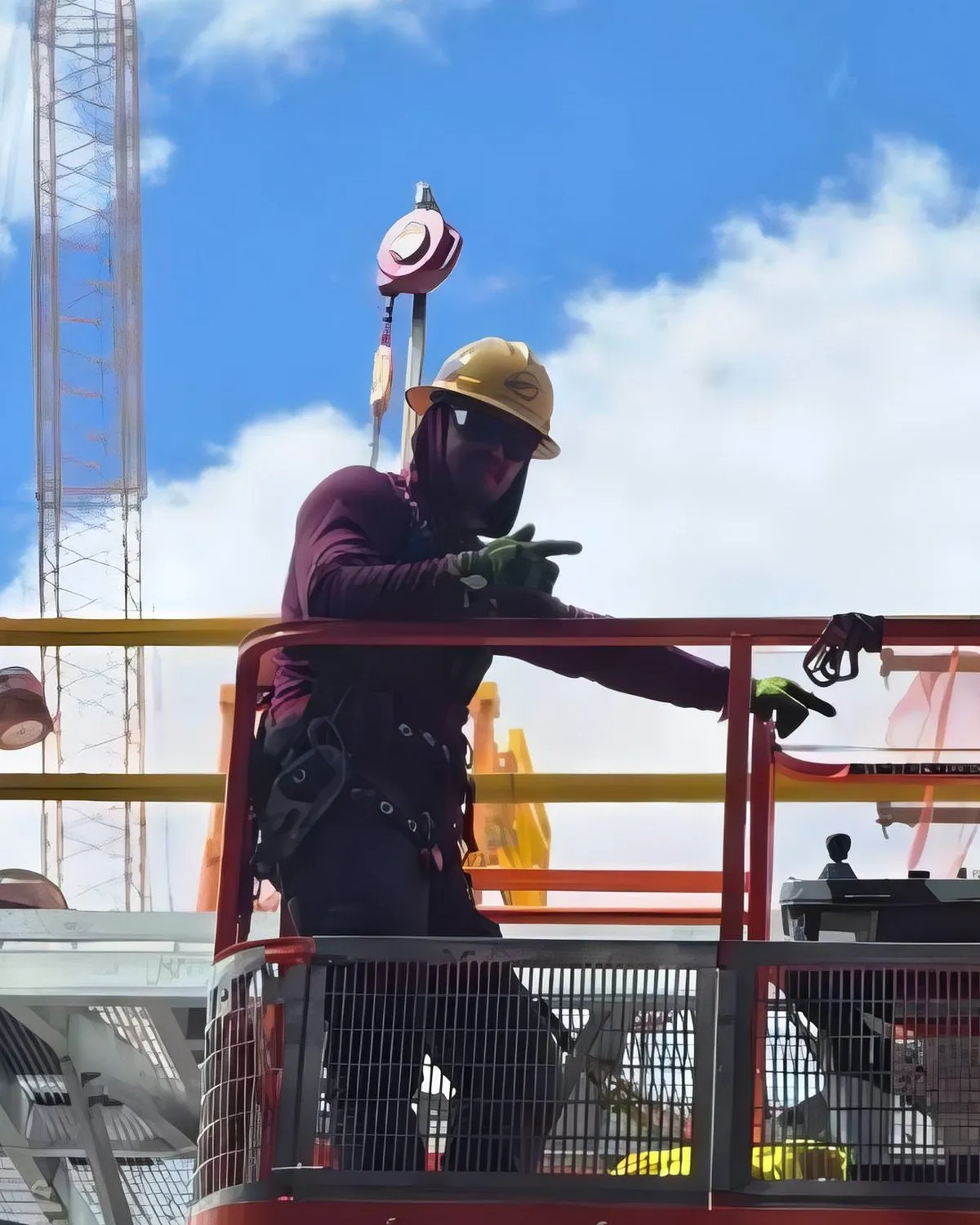 Andres Herrera working from a personnel platform on a refinery lift